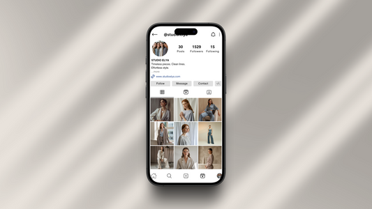 Instagram profile mockup of a minimalist fashion brand on a smartphone screen, showcasing a cohesive grid and clean brand aesthetic